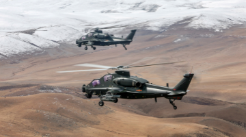 Helicopters fly in mountainous plateau area